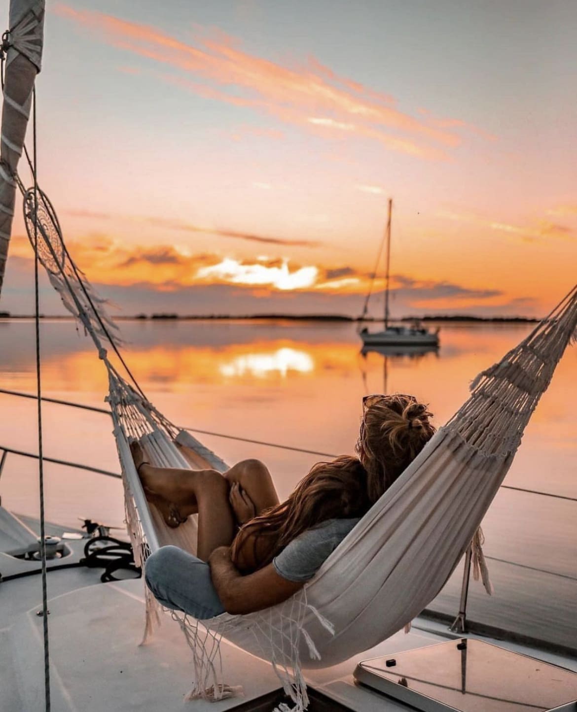 Couple watching the sunset from a hammock