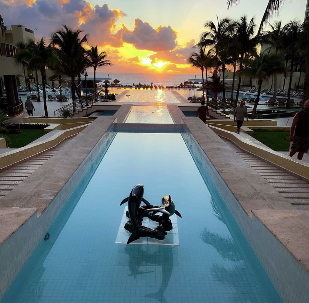 Picturesque sunset over a luxury hotel swimming pool in Cancun