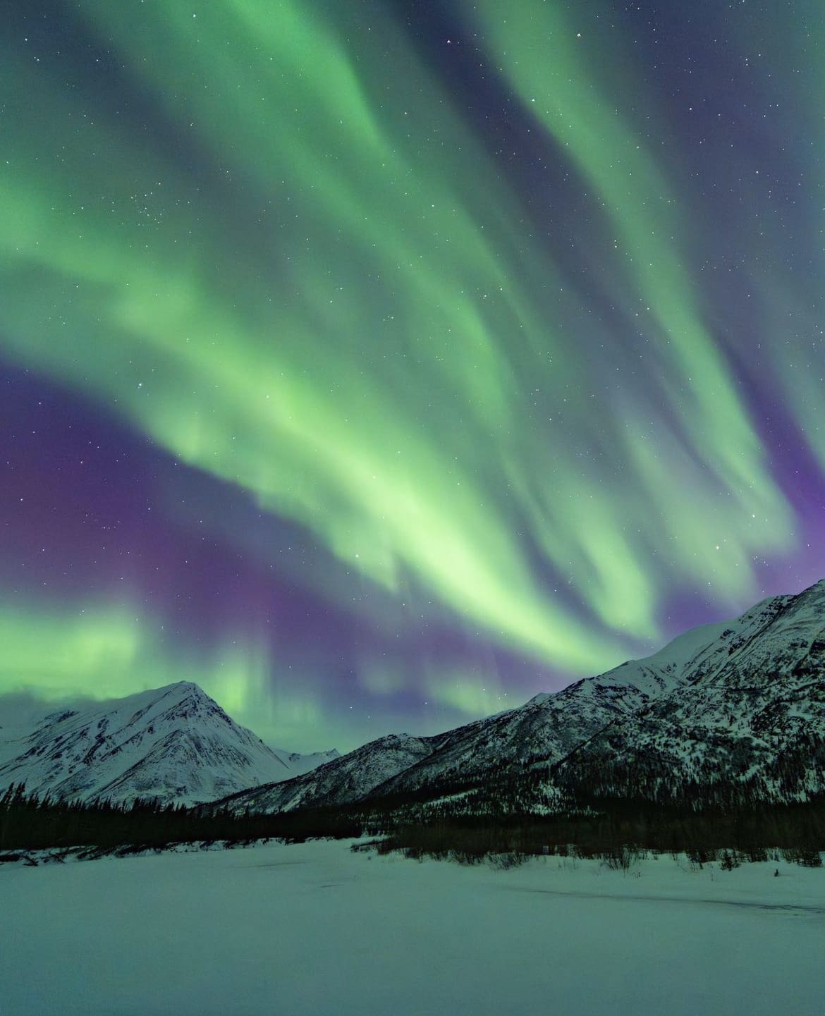 Magical aurora over mountains in Alaska