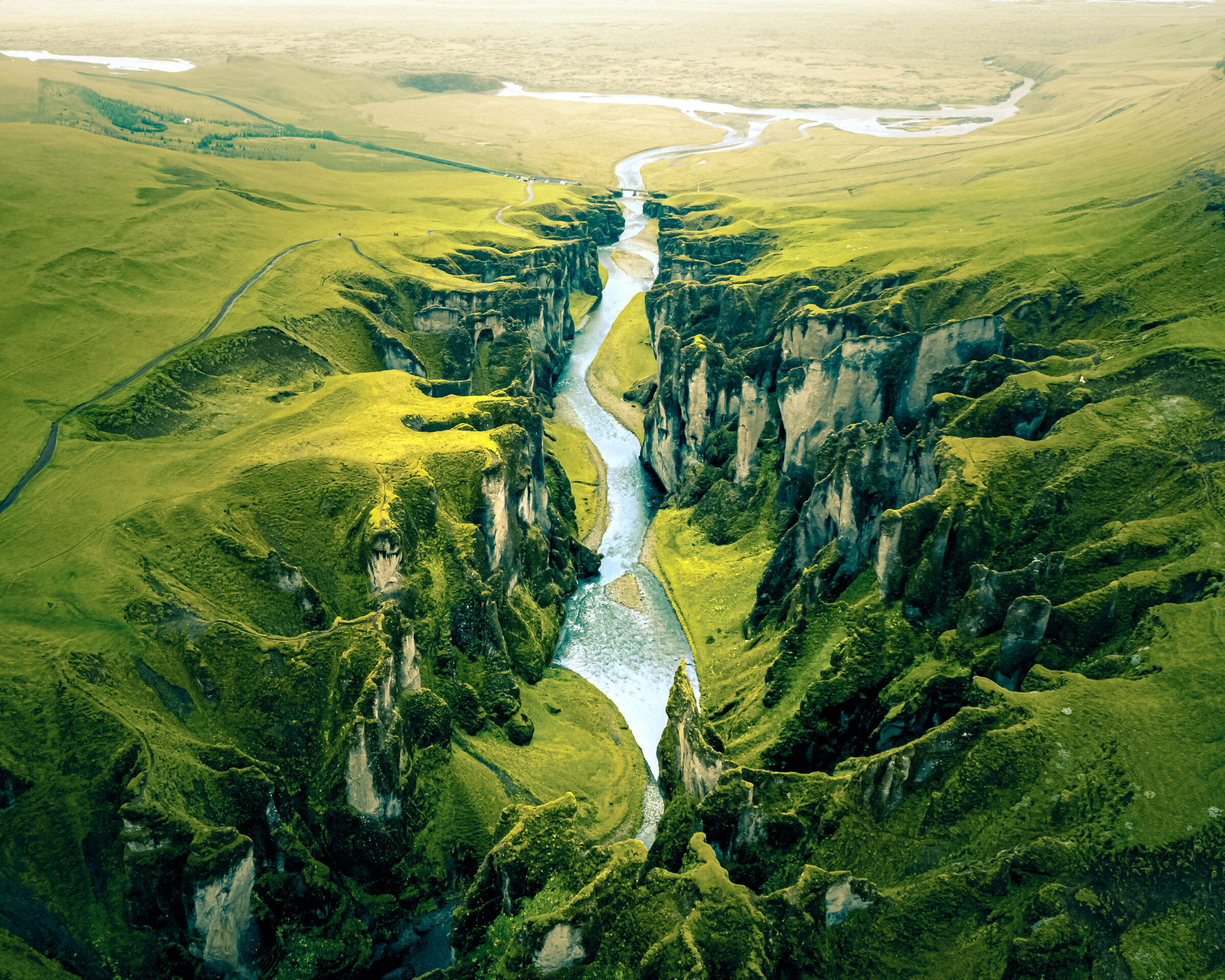Unique rugged landscape of Fjaðrárgljúfur canyon covered by beautiful green moss, located in southern Iceland. Aerial shot.