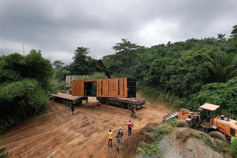 Moving a shipping container home into position on a site